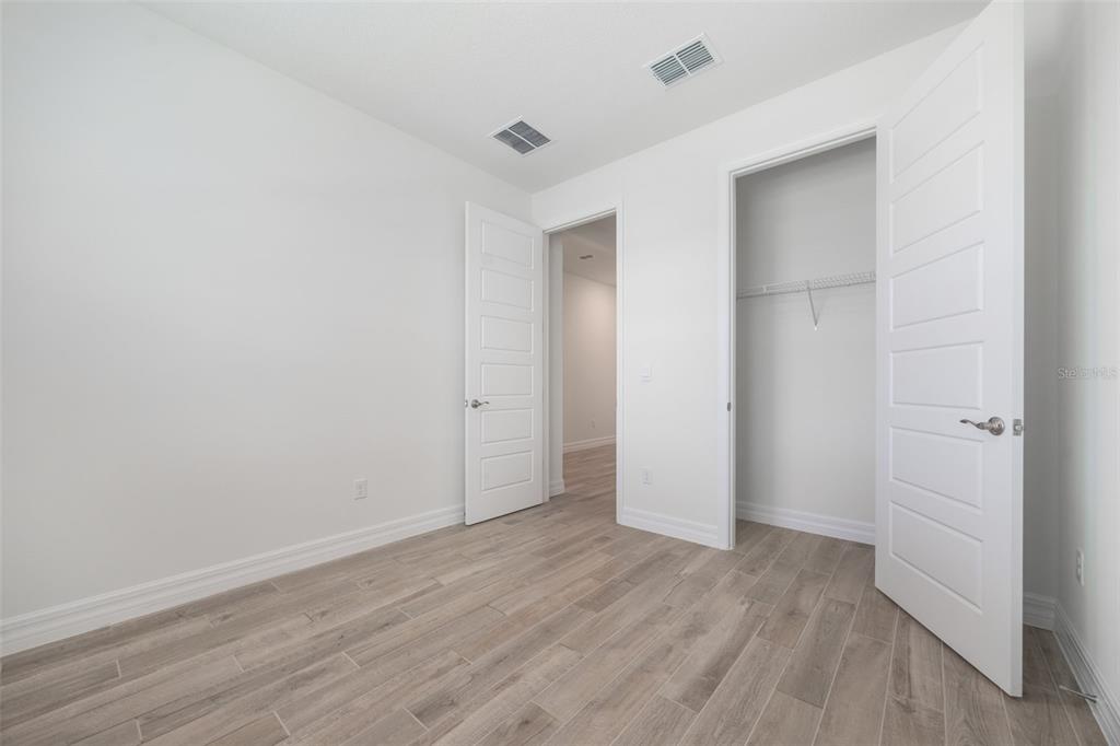 2277 Hamden Way Mount Dora, FL 32757 - Photo 3 of 32 a view of an empty room with wooden floor