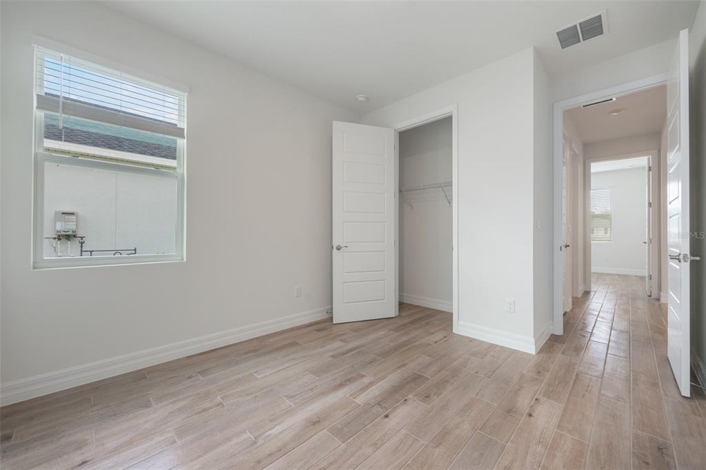 2277 Hamden Way Mount Dora, FL 32757 - Photo 7 of 32 a view of an empty room with wooden floor