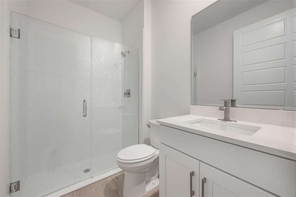 2277 Hamden Way Mount Dora, FL 32757 - Photo 8 of 32 a bathroom with a sink a toilet and shower