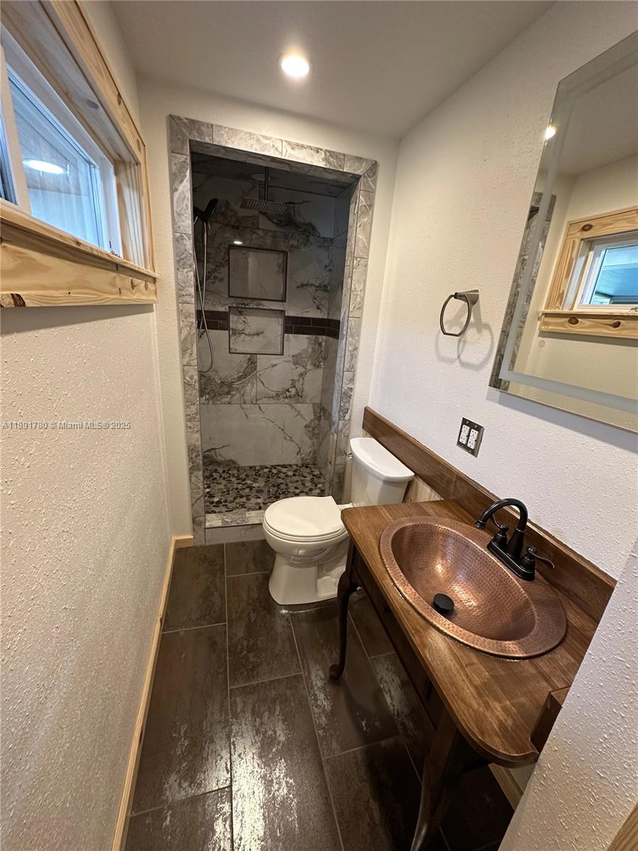 111 Springdale Road Sebring, FL 33870 - Photo 23 of 50 a bathroom with a sink a toilet and shower