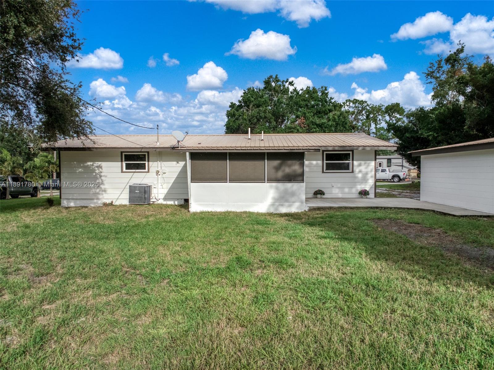 111 Springdale Road Sebring, FL 33870 - Photo 36 of 50 a front view of house with yard and trees in the background