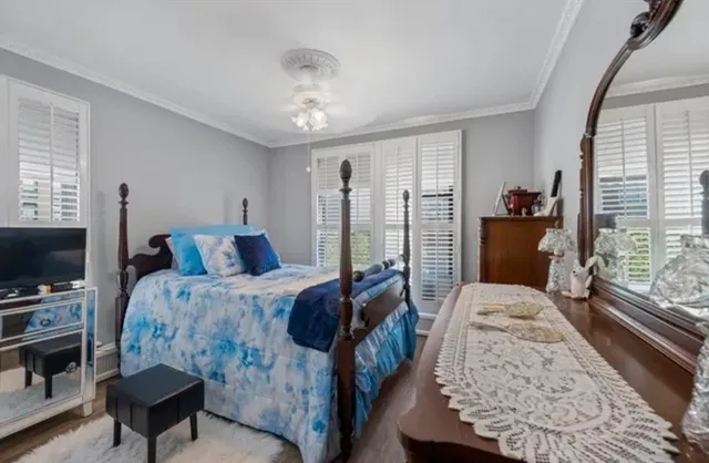 a spacious bedroom with a bed window and a flat screen tv