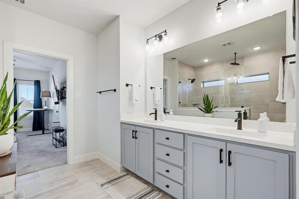 9341 Loggerhead Way Fort Worth, TX 76118 - Photo 22 of 35 Dual vanity with light gray cabinetry and white countertops