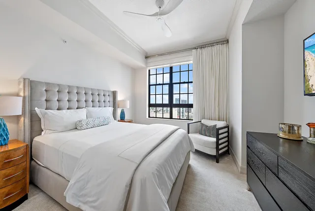 a bathroom with a toilet a sink a mirror and shower