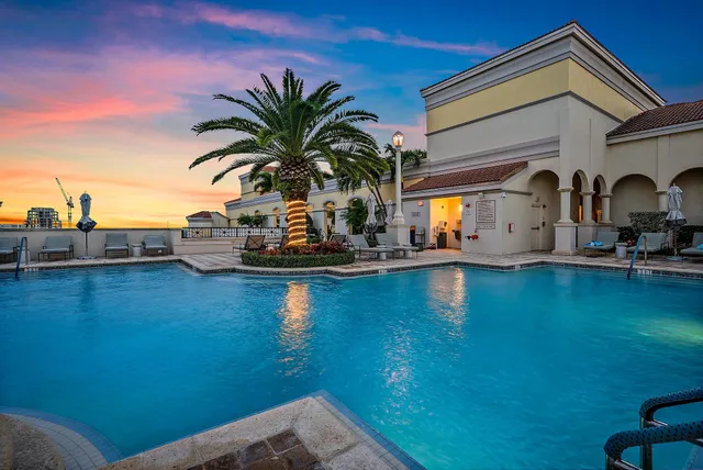 a living room with patio furniture and a potted plant