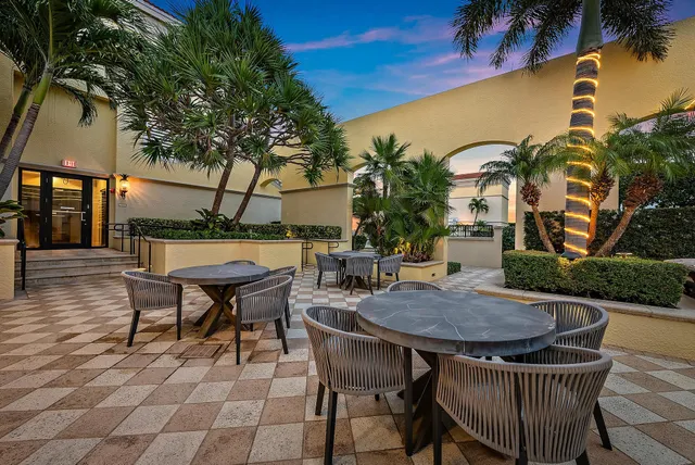 a view of a patio with table and chairs with wooden floor and fence
