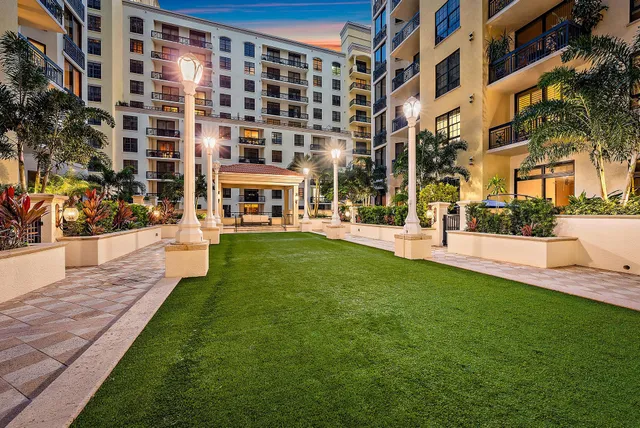 a living room with furniture kitchen view and a large window