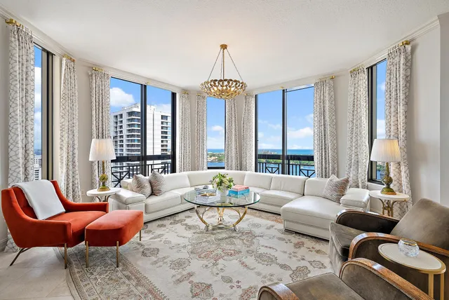 a living room with furniture a table and a chandelier