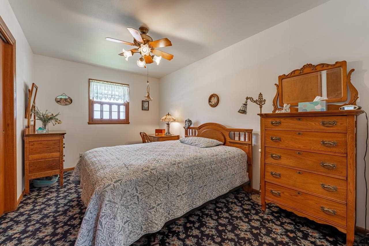 438 Rebecca Road Belvidere, IL 61008 - Photo 13 of 28 a bedroom with a bed and a dresser in it