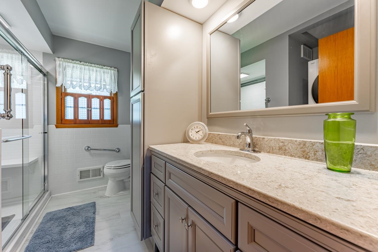 438 Rebecca Road Belvidere, IL 61008 - Photo 18 of 28 a bathroom with a granite countertop sink and a mirror