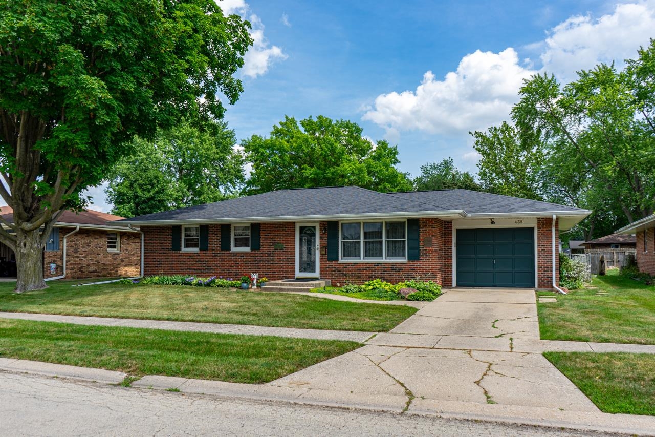 438 Rebecca Road Belvidere, IL 61008 - Photo 2 of 28 a front view of house with a garden and trees