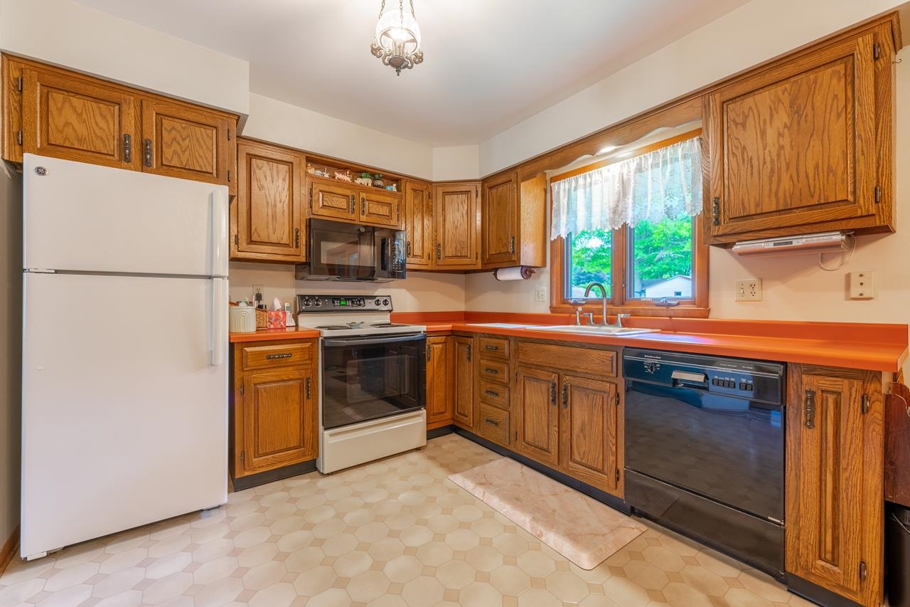 438 Rebecca Road Belvidere, IL 61008 - Photo 9 of 28 a kitchen with stainless steel appliances granite countertop a stove a sink and a refrigerator