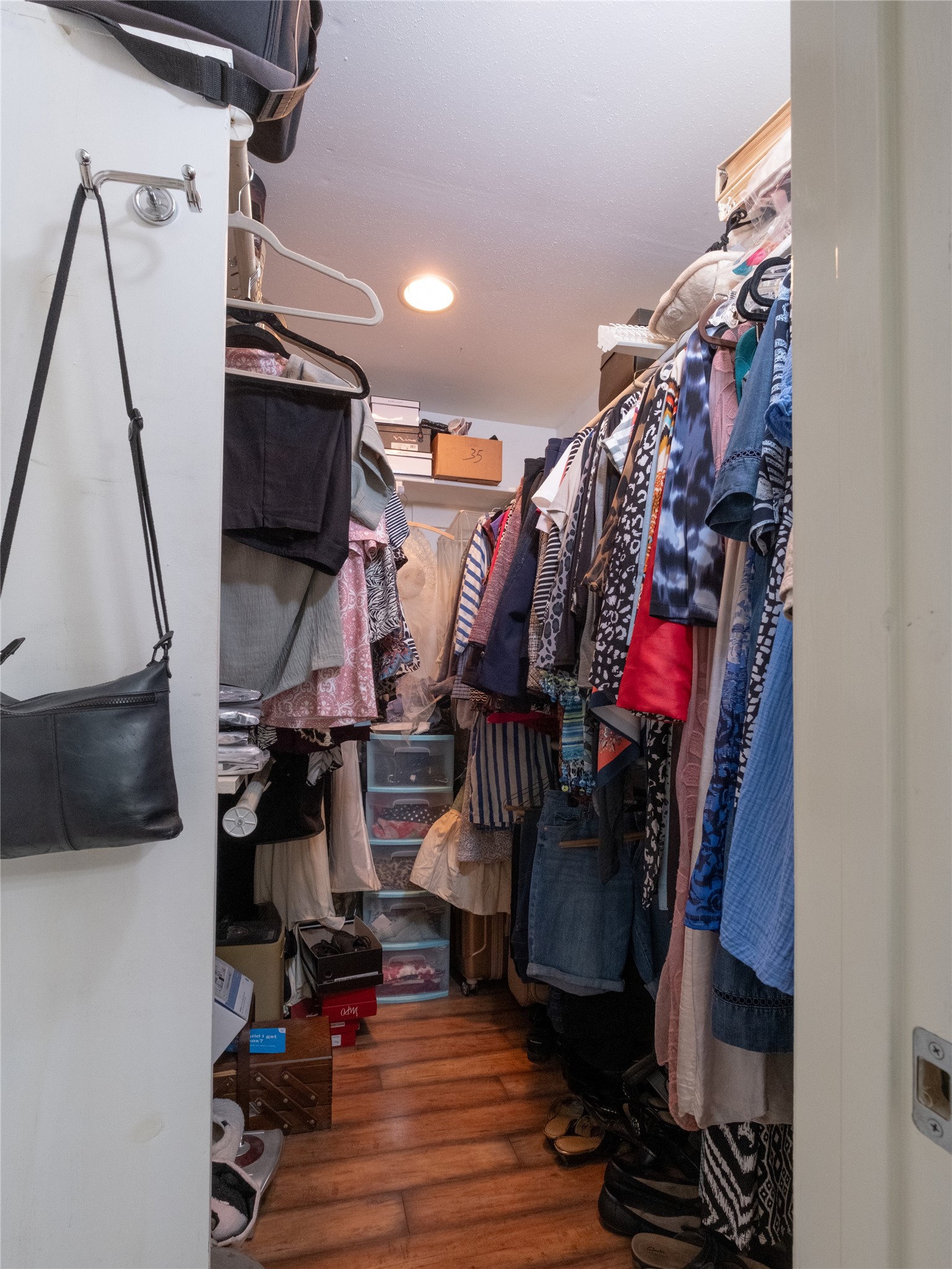 7315 Weatherhill Lane Houston, TX 77041 - Photo 30 of 40 This photo shows a walk-in closet with ample storage space, featuring hanging rod and shelves. This closet is a practical and organized area for clothing and accessories.