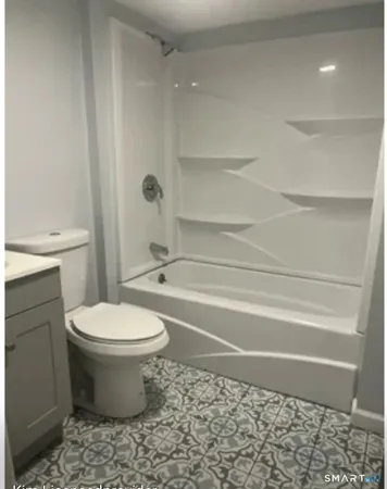 a bathroom with a toilet and a shower