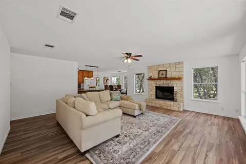 a living room with furniture a fireplace and a table