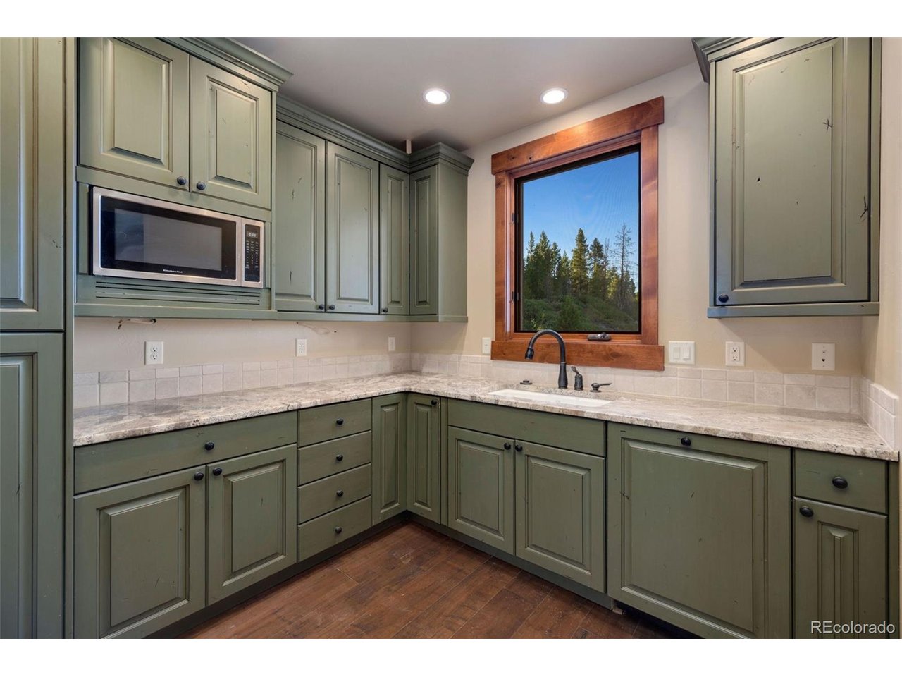 5200 Jackson Road Walden, CO 80480 - Photo 12 of 40 Second prep kitchen with additional custom cabinetry, dishwasher, sink and microwave