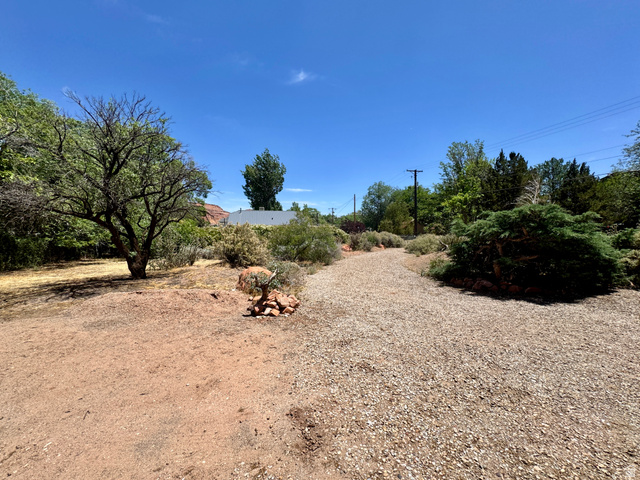 178 Walnut Lane Moab, UT 84532 - Photo 22 of 25 Gravel pathway bordered by natural landscaping and mature trees