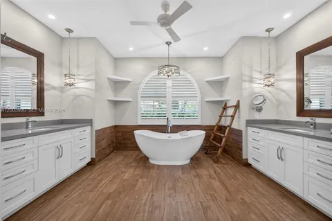 a large bathroom with a large window sink and mirror