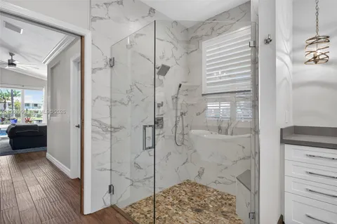 a bathroom with a glass shower door