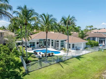 a view of a house with swimming pool and sitting area