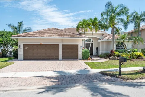 a front view of a house with a yard and a garage
