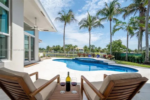 a view of swimming pool with outdoor seating and plants