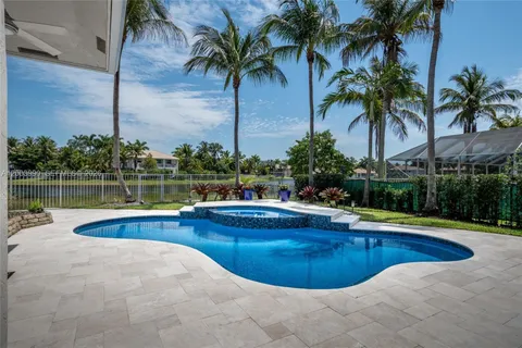 a view of a swimming pool with a lounge chair