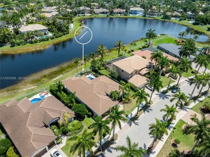 an aerial view of a house with a lake view