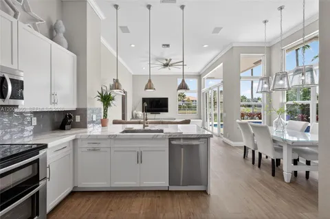 a kitchen with stainless steel appliances kitchen island a cabinets and wooden floor