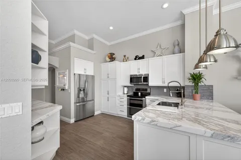 a kitchen with refrigerator and cabinets
