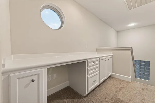 a kitchen with cabinets and a stove