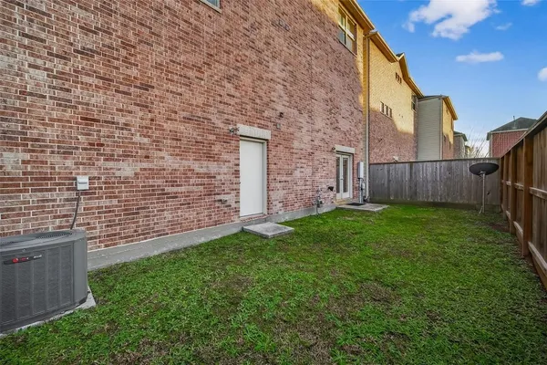 a view of a backyard with brick wall