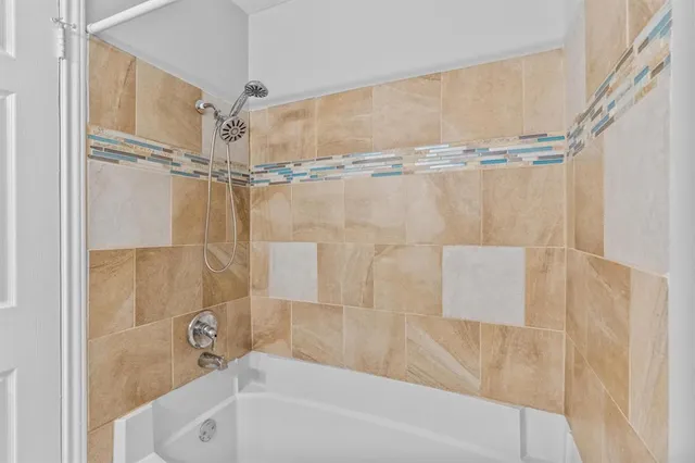 a bathroom with a shower and a bathtub