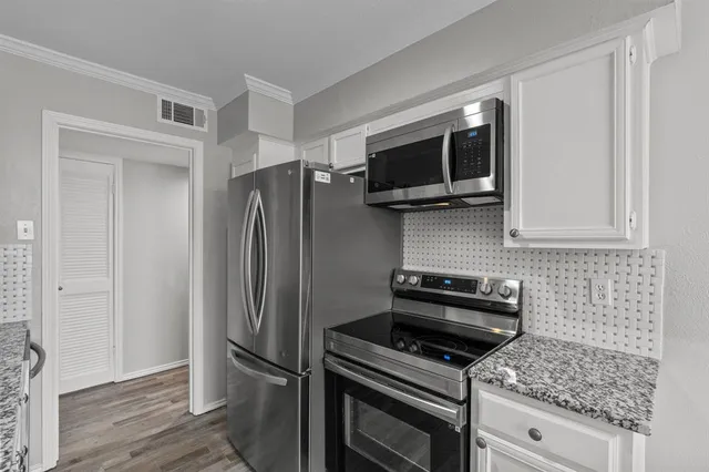 a kitchen with appliances and cabinets