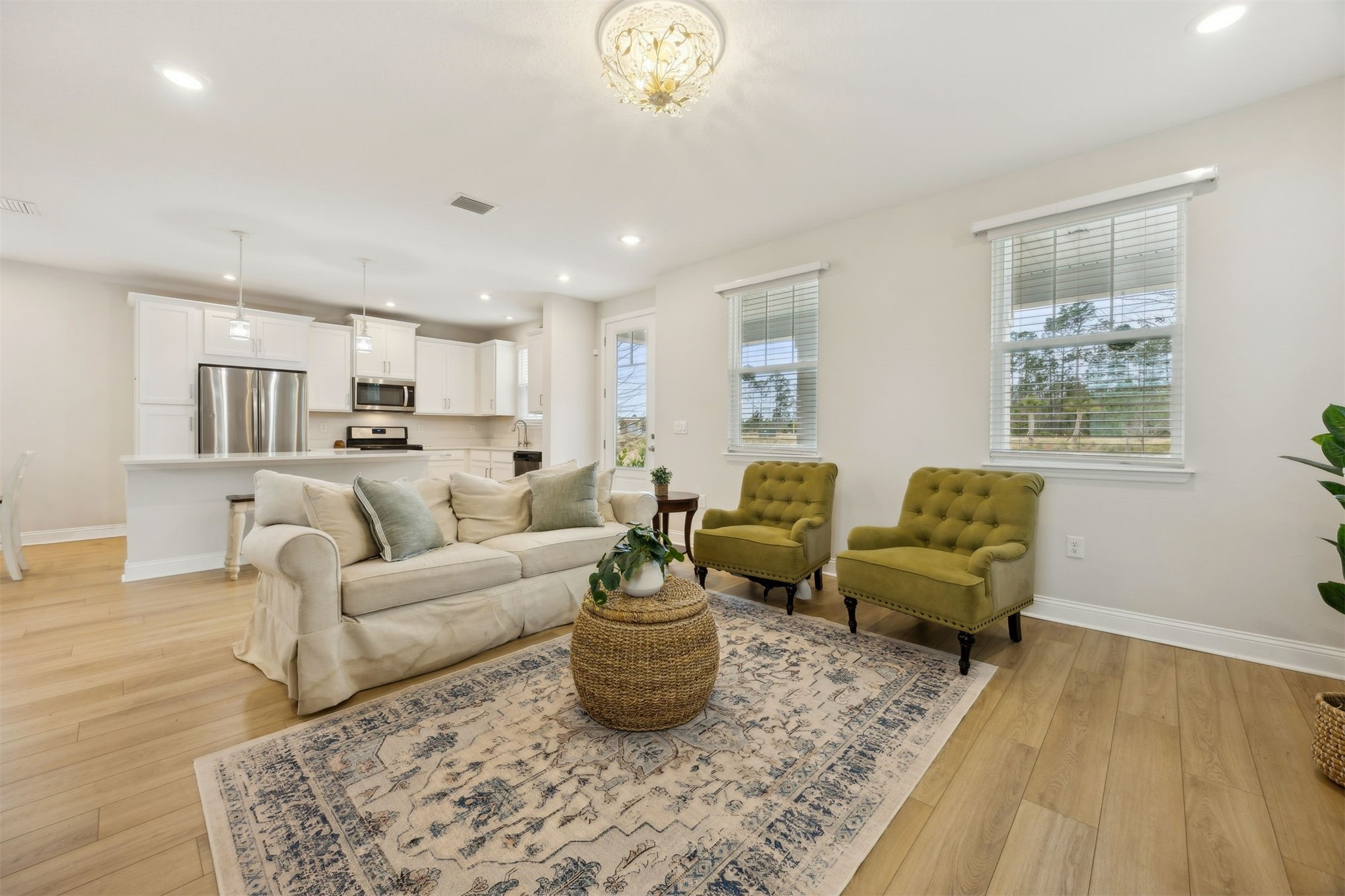 141 Redbud Lane Yulee, FL 32097 - Photo 11 of 61 a living room with furniture and a chandelier
