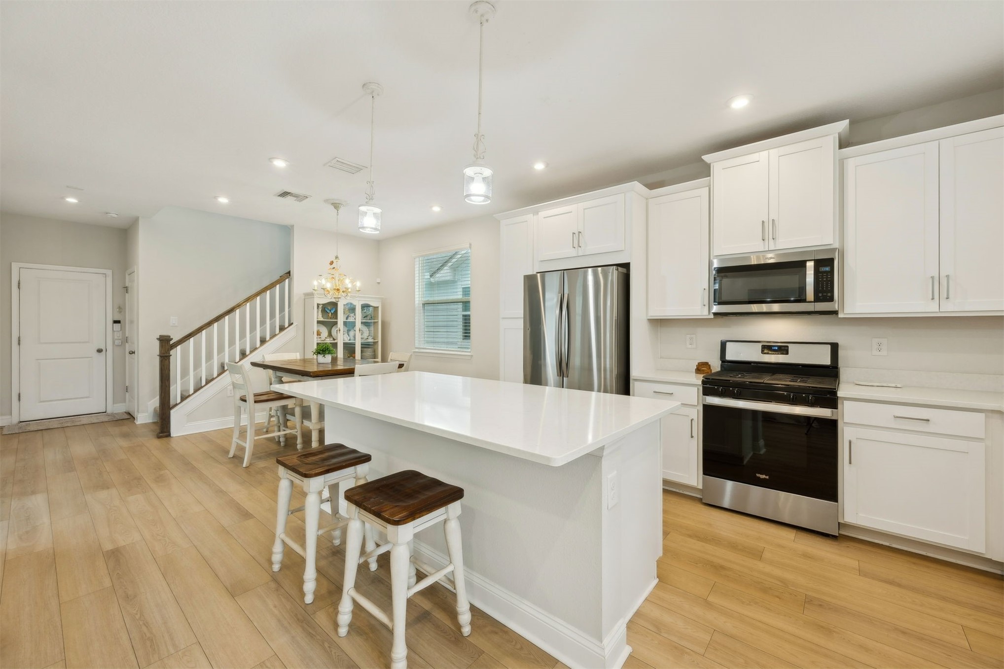 141 Redbud Lane Yulee, FL 32097 - Photo 14 of 61 a large white kitchen with wooden floor and a stove top oven