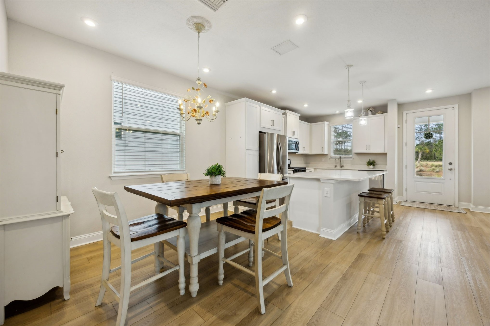141 Redbud Lane Yulee, FL 32097 - Photo 24 of 61 a view of a dining room with furniture and wooden floor