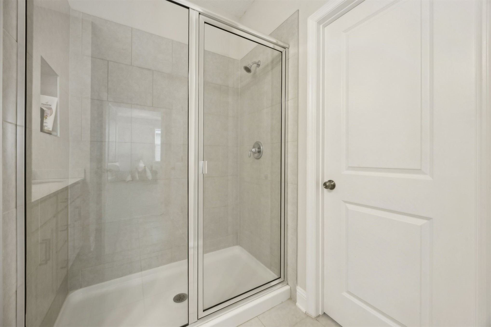141 Redbud Lane Yulee, FL 32097 - Photo 33 of 61 a bathroom with a glass shower door