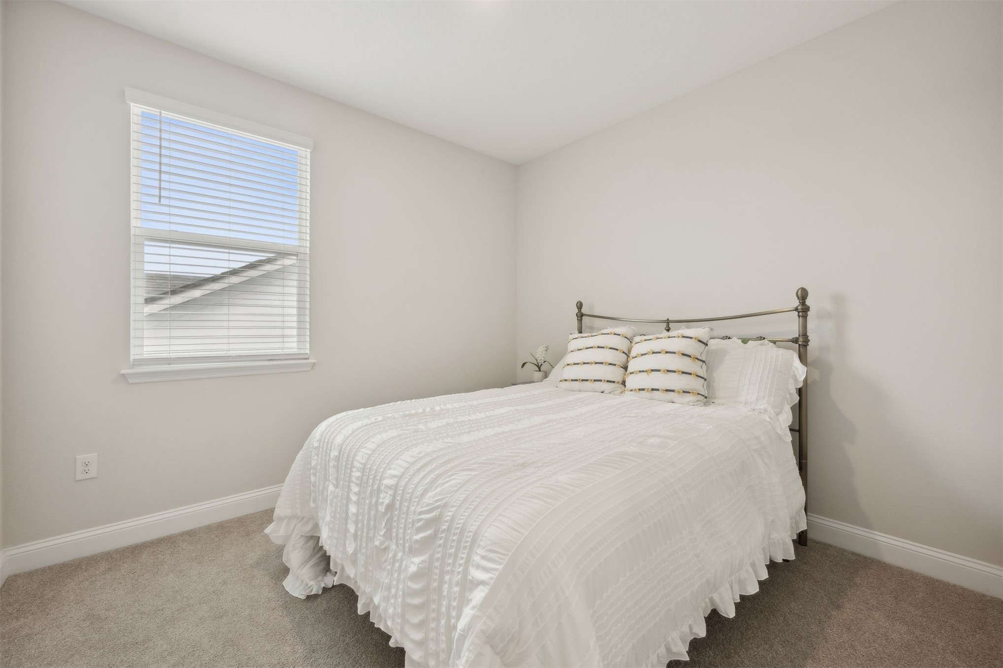 141 Redbud Lane Yulee, FL 32097 - Photo 35 of 61 a large bed sitting in a bedroom next to a window