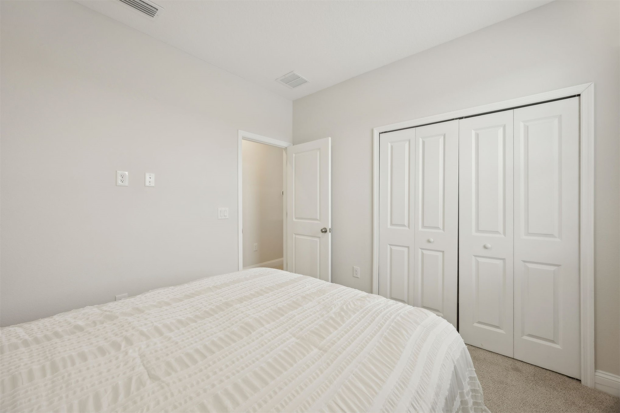 141 Redbud Lane Yulee, FL 32097 - Photo 36 of 61 a bedroom with a bed and curtain