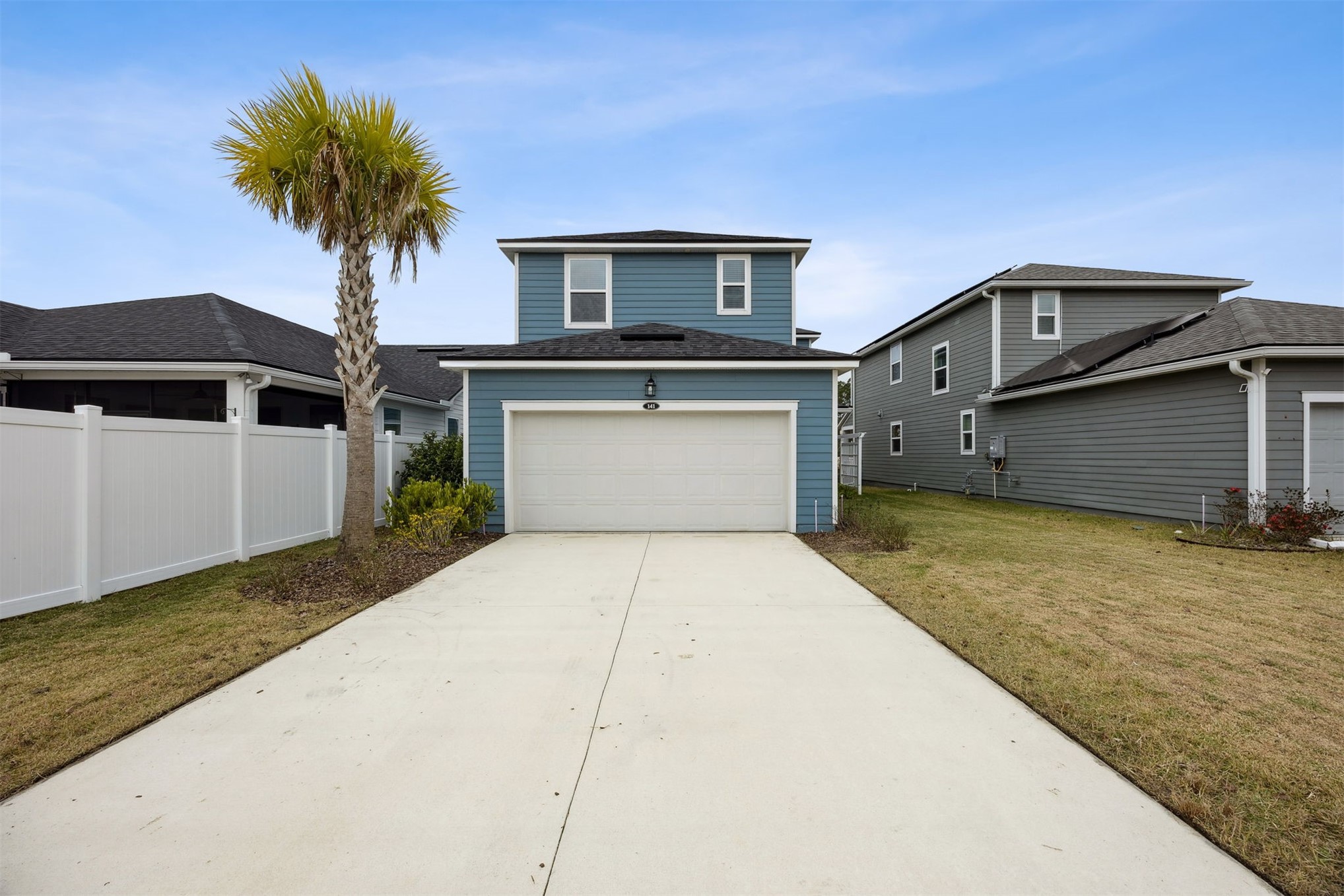141 Redbud Lane Yulee, FL 32097 - Photo 47 of 61 a front view of a house with yard and garage