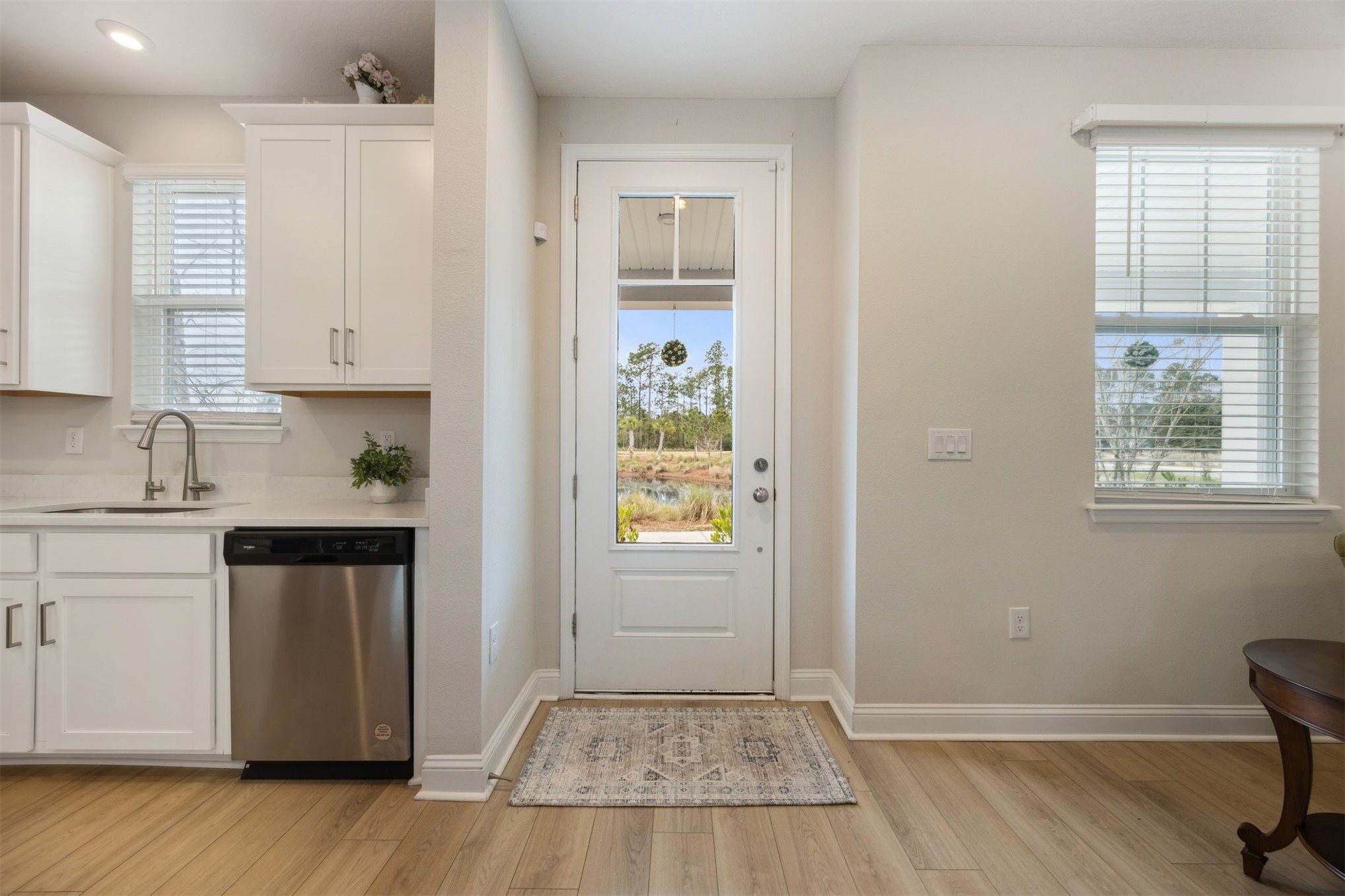 141 Redbud Lane Yulee, FL 32097 - Photo 8 of 61 a kitchen with wooden floors and white appliances