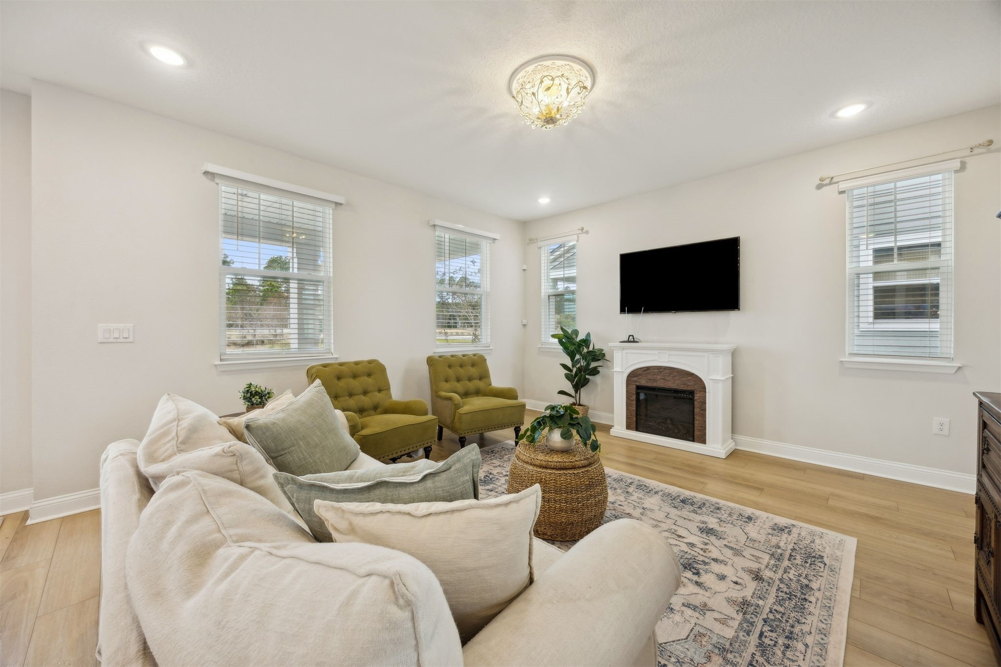 141 Redbud Lane Yulee, FL 32097 - Photo 10 of 61 a living room with furniture a fireplace and a flat screen tv