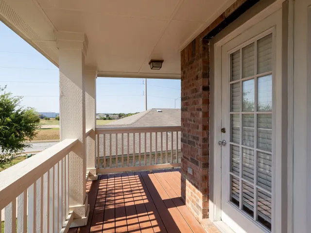 a view of a door and wooden floor