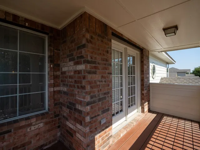 a view of a room with wooden floor and windows