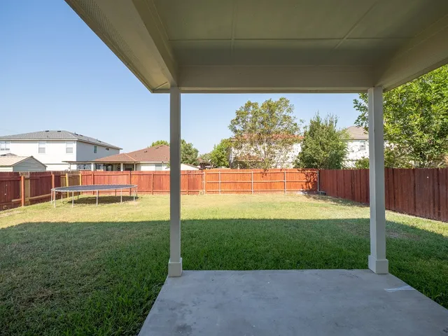 a view of backyard with porch