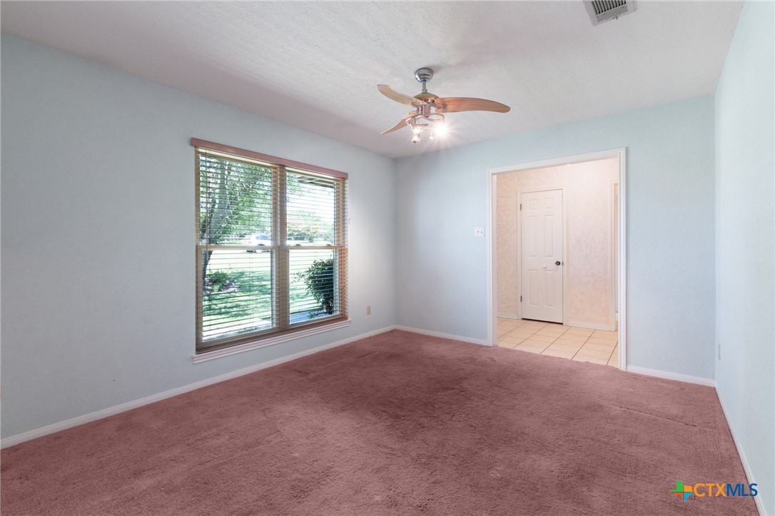 3391 Lois Lane Kempner, TX 76539 - Photo 18 of 35 a view of an empty room with chandelier fan and fire place