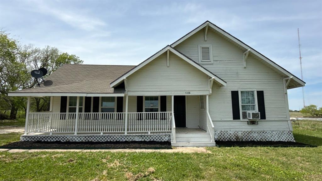 1338 State Highway 121 Bonham, TX 75418 - Photo 1 of 32 a front view of a house with a garden