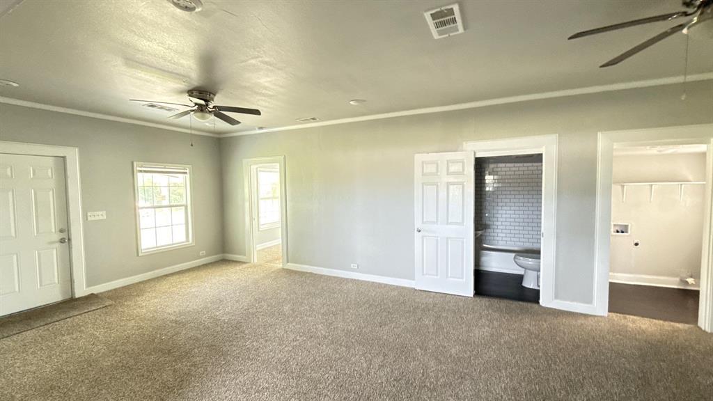 1338 State Highway 121 Bonham, TX 75418 - Photo 9 of 32 an empty room with windows and cabinet