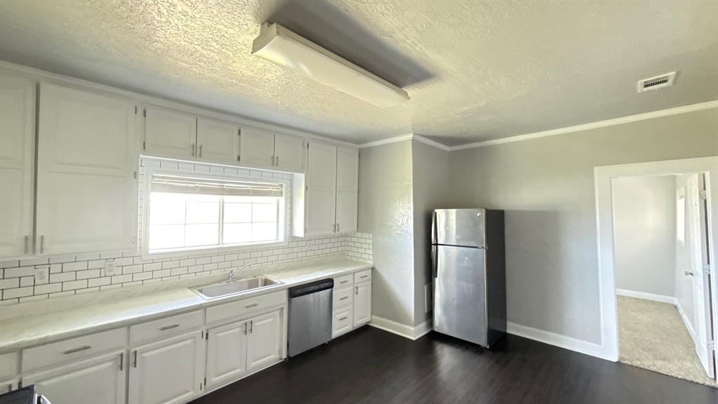 1338 State Highway 121 Bonham, TX 75418 - Photo 13 of 32 a kitchen with a refrigerator and a sink